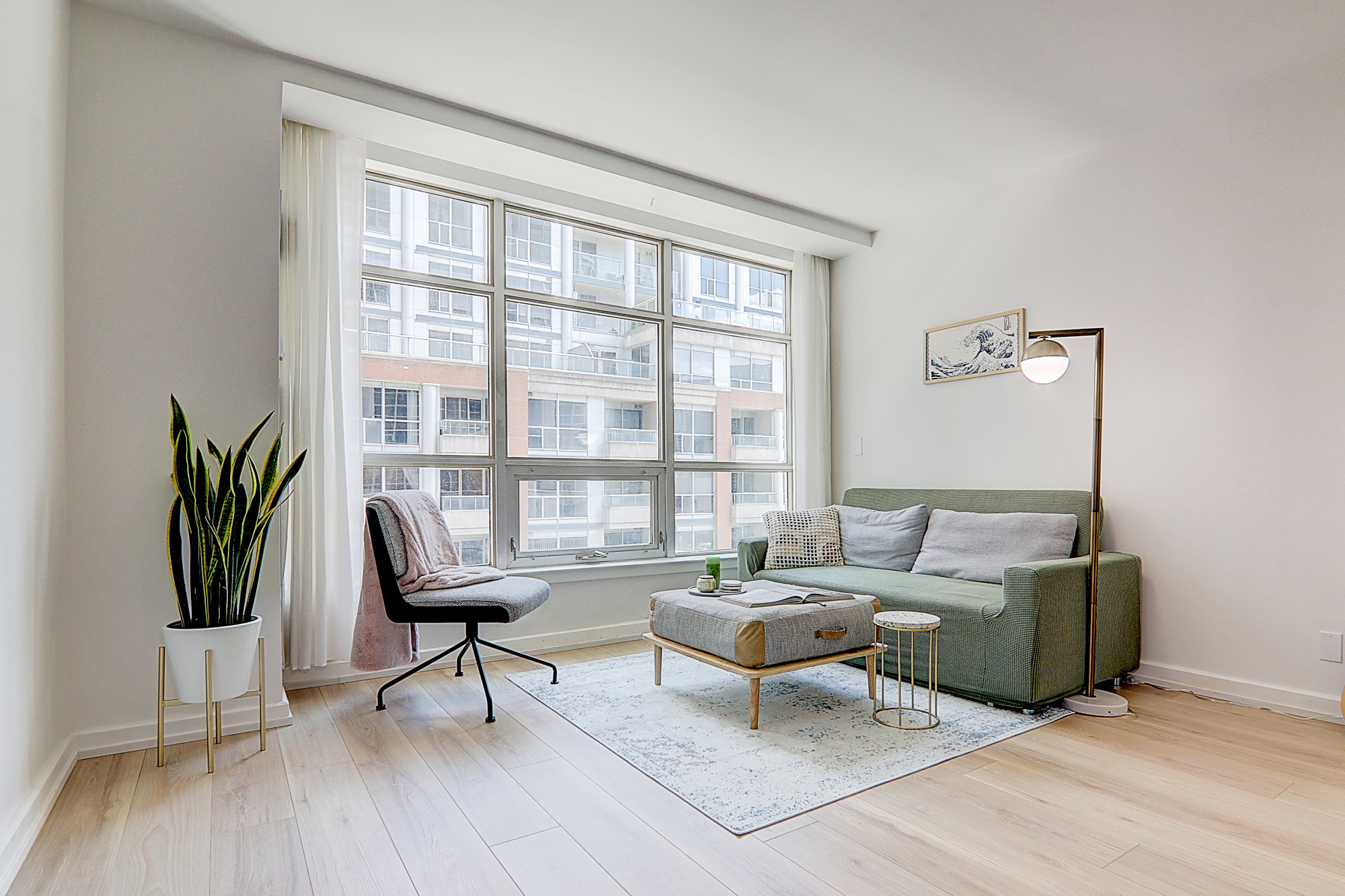 Spacious and bright living room with a view of the CN Tower